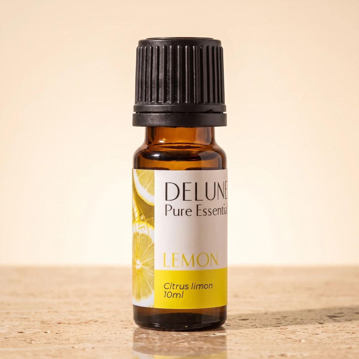 Frasco de vidrio ámbar de 10 ml del Aceite esencial puro de limón amarillo de Delune sobre travertino cálido