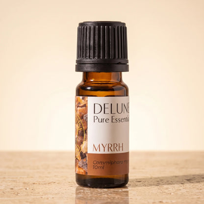 Delune Myrrh Pure Essential Oil, 10ml amber glass bottle on warm travertine stone