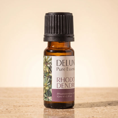 Aceite esencial puro de hoja de rododendro Delune, frasco de vidrio ámbar de 10 ml sobre piedra travertino cálida