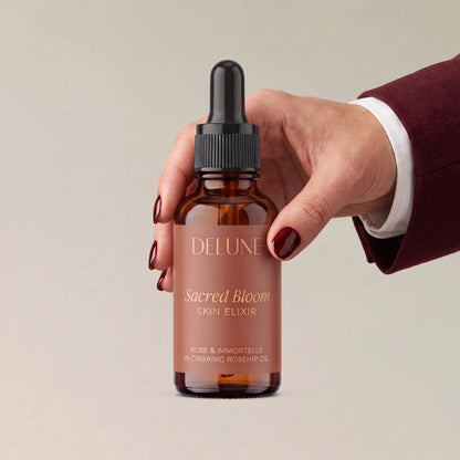 Hand holding Delune Sacred Bloom Skin Elixir